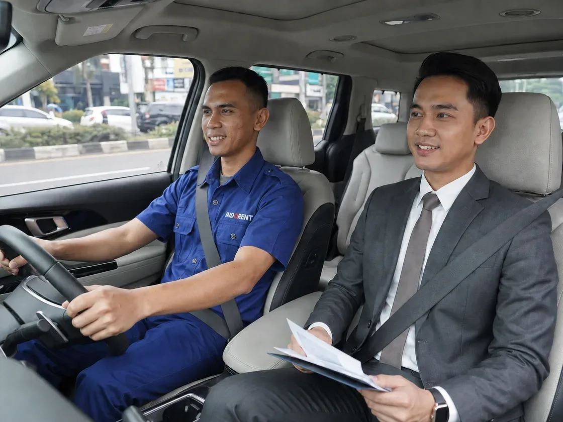 A uniformed INDORENT driver chauffeuring a customer