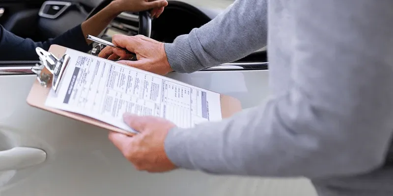 Checking a rental car's document sheet